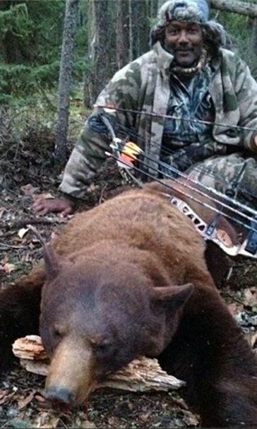 NBA legend Karl Malone takes down bear with bow and arrow